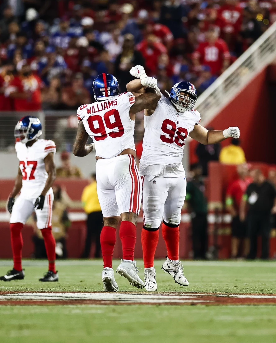 Davidson (98) celebrating a stop with Leonard Williams
